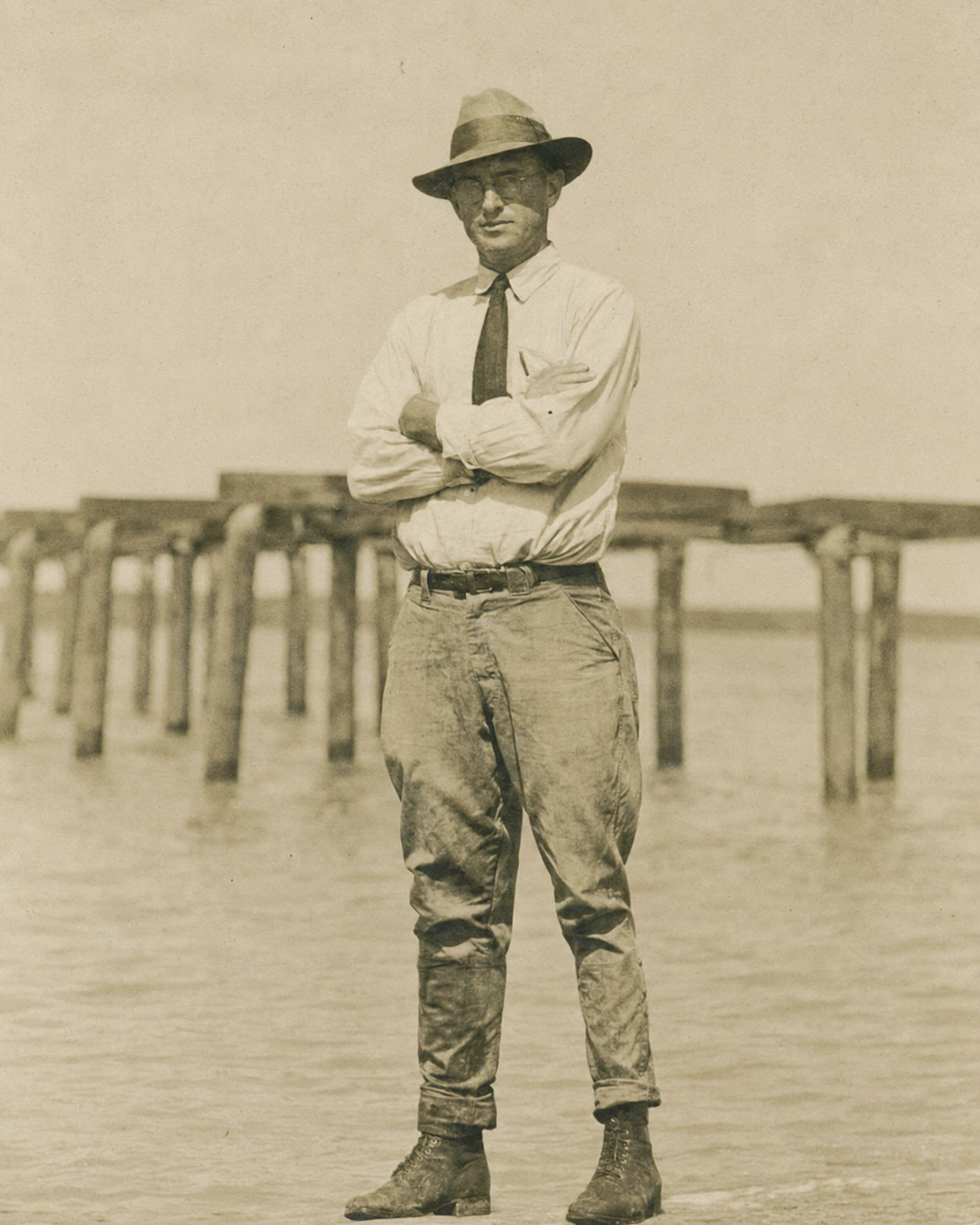 John Albert Benton standing on a pier with his arms crossed