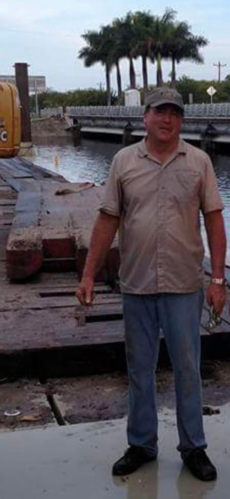 Roy Benton Jr. standing beside a marine construction jobsite